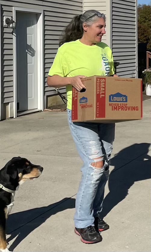 Kristine Scalzi loading donated ARCs for the Worldbuilders Fundraiser while Charlie the dog supervises.